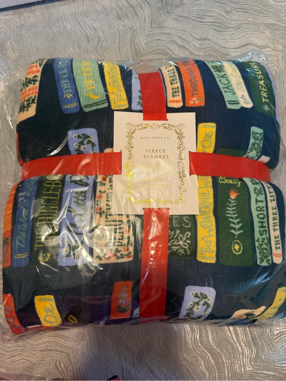 Rifle Paper Co. Navy Fleece Blanket with Multicolor Book Spine Print
